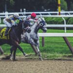 two man riding horse while racing