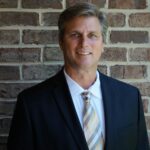 portrait photography of man wearing black suit jacket